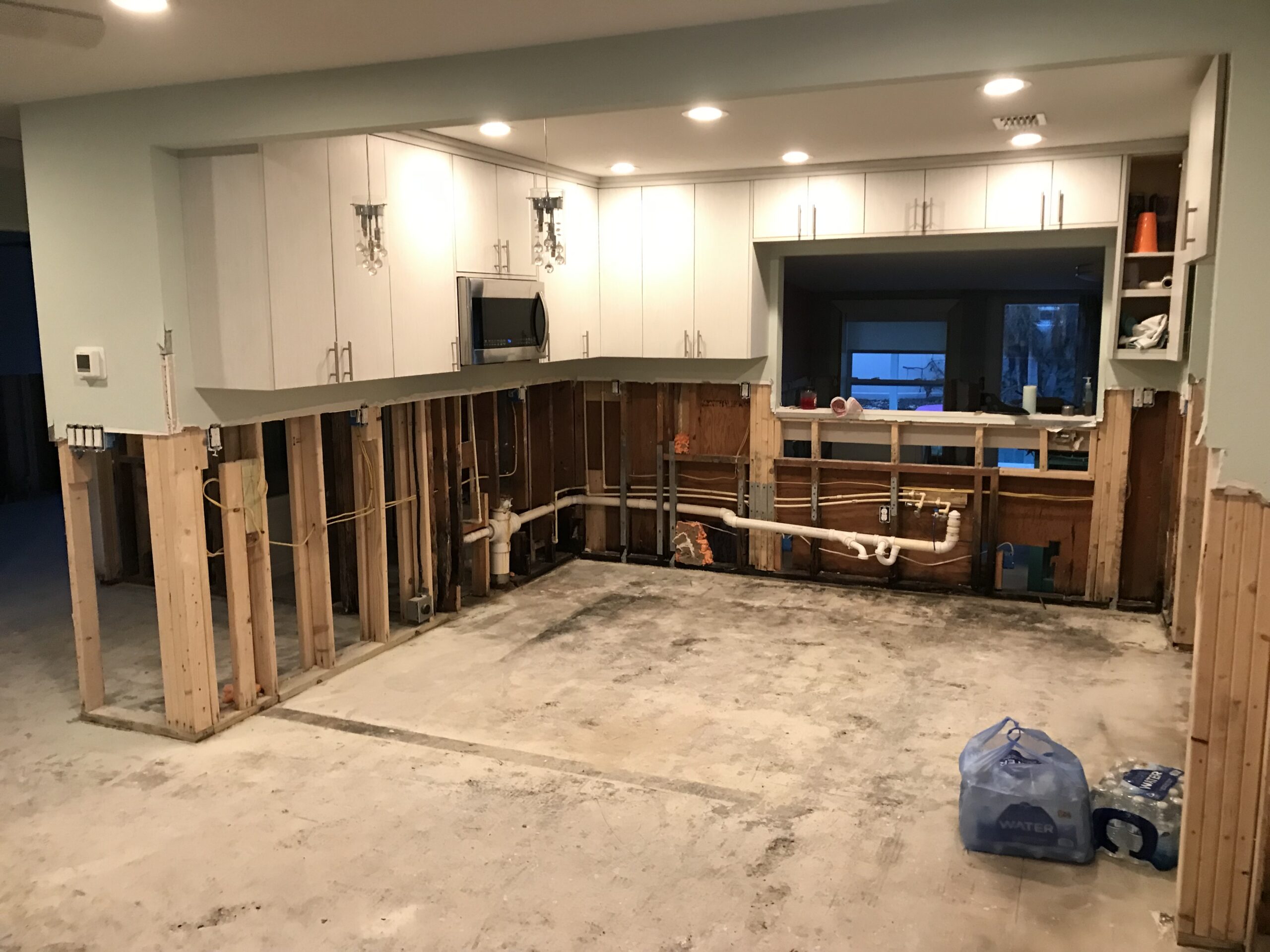Kitchen and living area torn out to the studs after water damage
