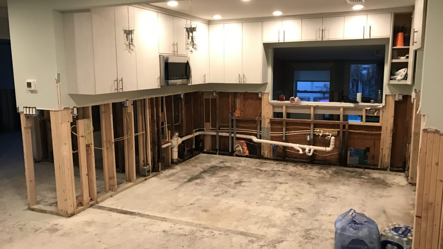 Kitchen and living area torn out to the studs after water damage
